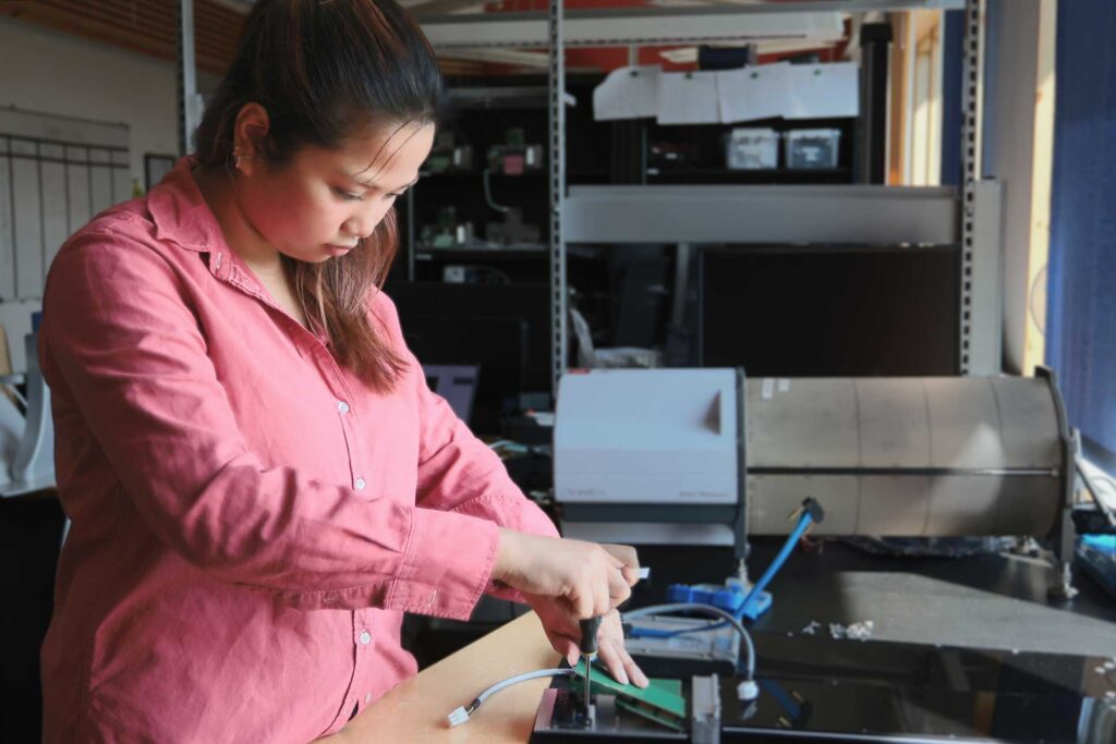 Support staff working on hardware at a workbench
